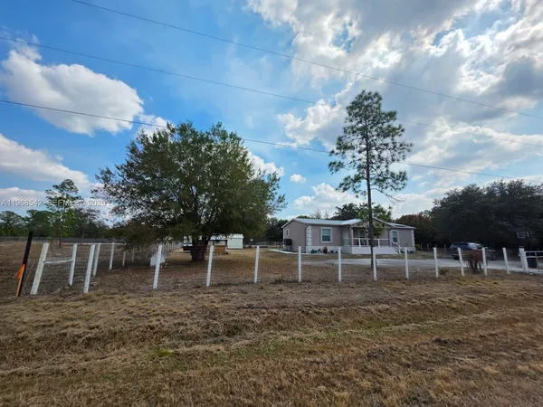 a view of a backyard with table and chairs