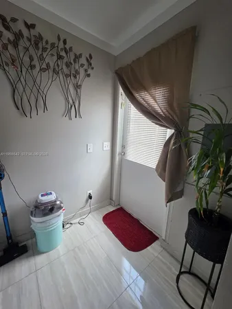 a bedroom with a bed and a potted plant