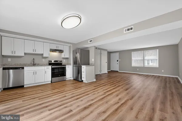 a view of kitchen with granite countertop cabinets and stainless steel appliances