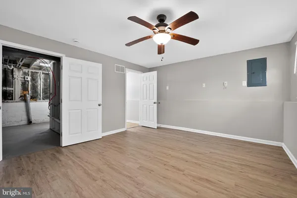 a view of empty room with wooden floor