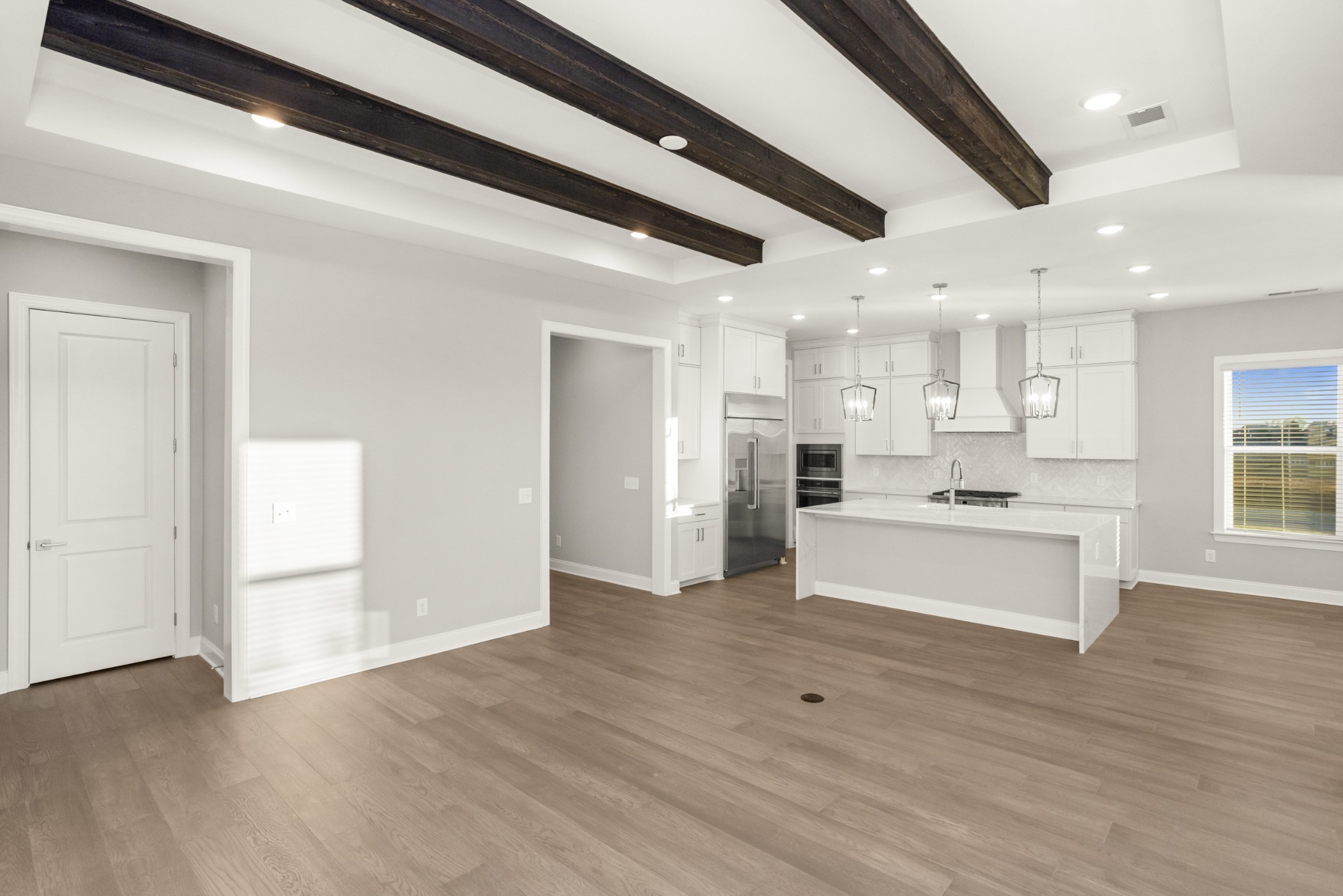 1933 Harmony Road Spring Hill, TN 37174 - Photo 21 of 50 a room with stainless steel appliances kitchen island wooden floors and view living room
