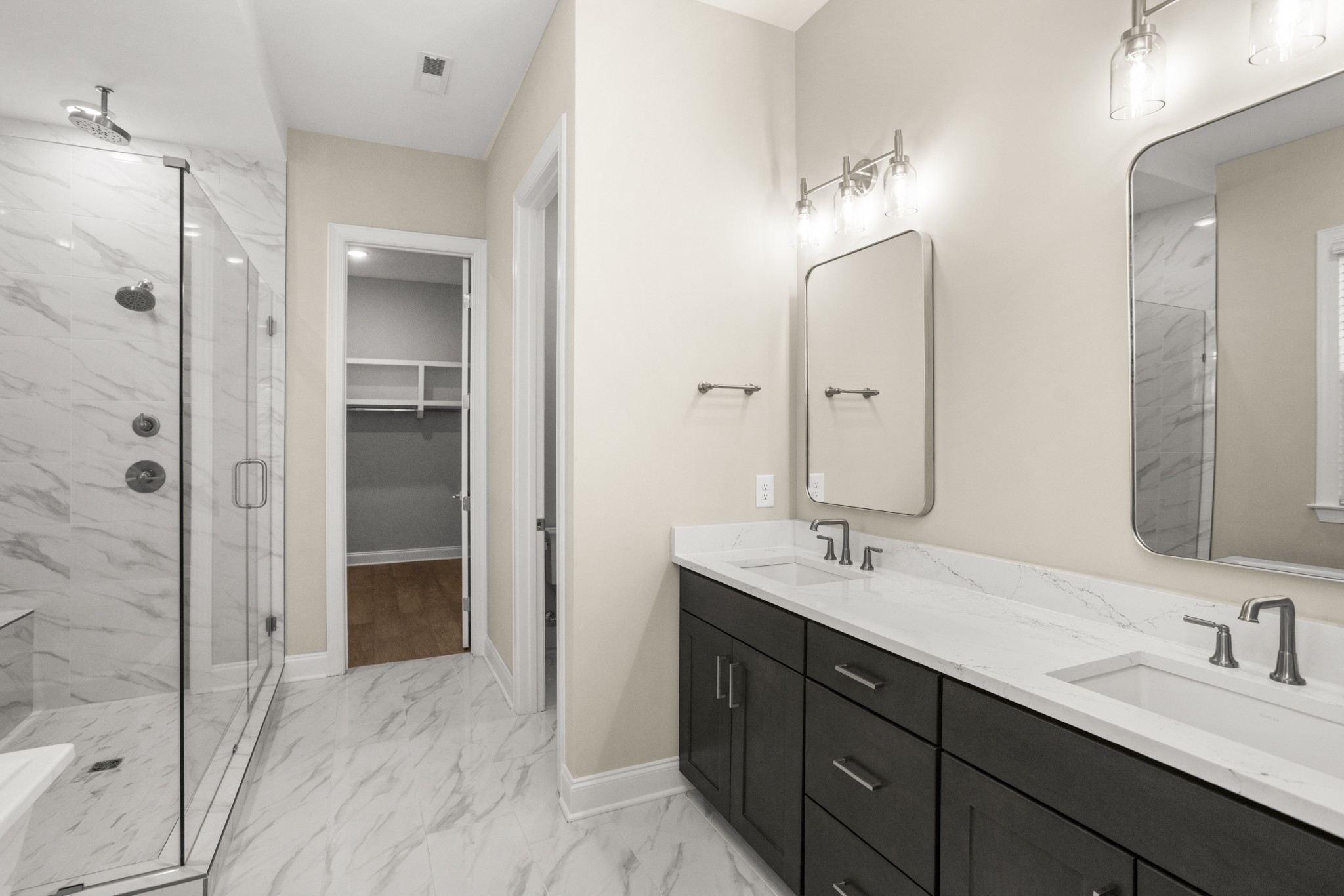 1933 Harmony Road Spring Hill, TN 37174 - Photo 27 of 50 a bathroom with a double vanity sink mirror and shower