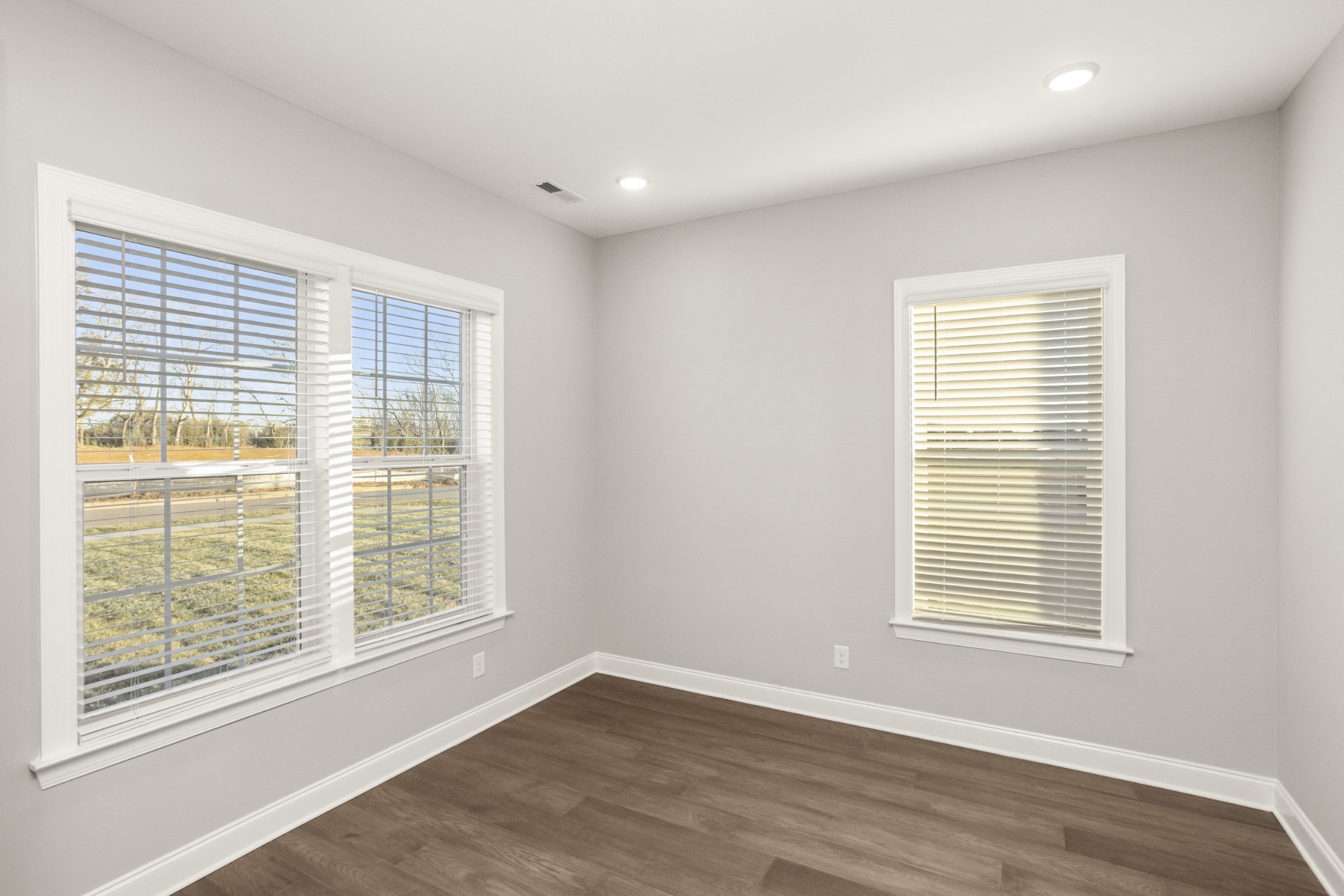 1933 Harmony Road Spring Hill, TN 37174 - Photo 5 of 50 a view of an empty room with wooden floor and a window