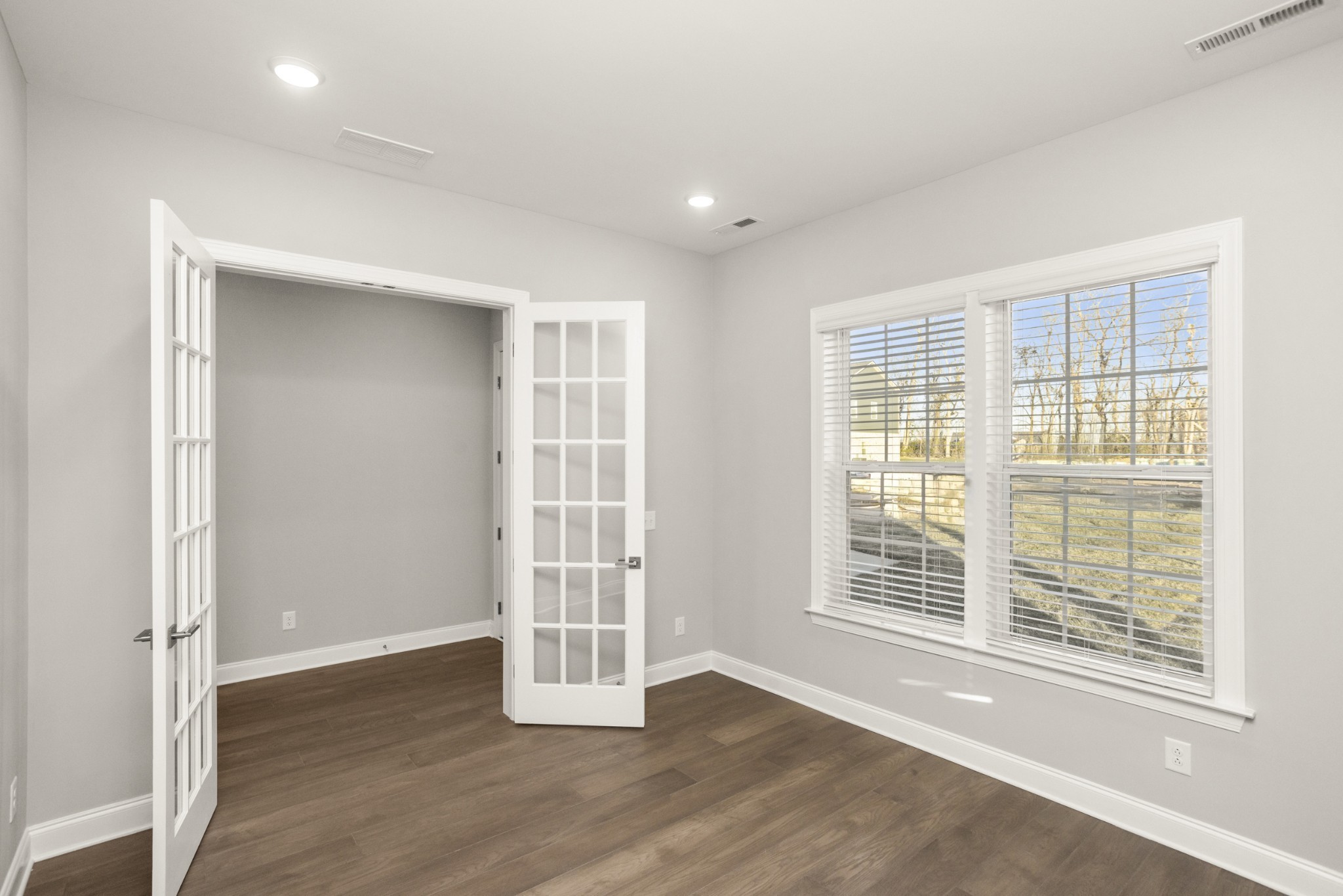 1933 Harmony Road Spring Hill, TN 37174 - Photo 6 of 50 an empty room with wooden floor and windows