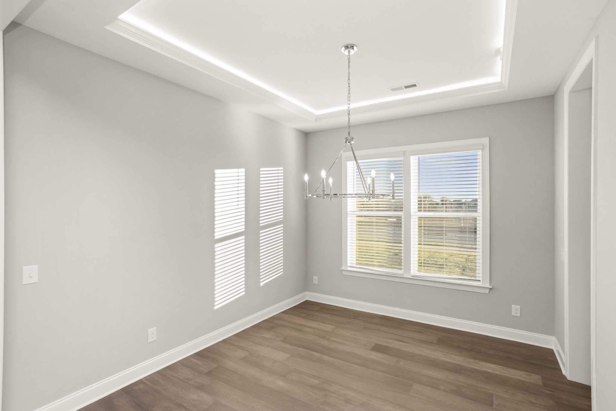 1933 Harmony Road Spring Hill, TN 37174 - Photo 9 of 50 a view of an empty room with a window and wooden floor