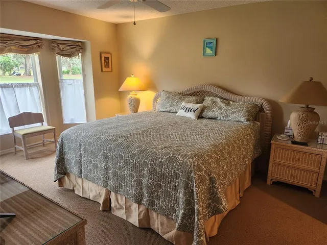 a bedroom with a bed and a lamp with window