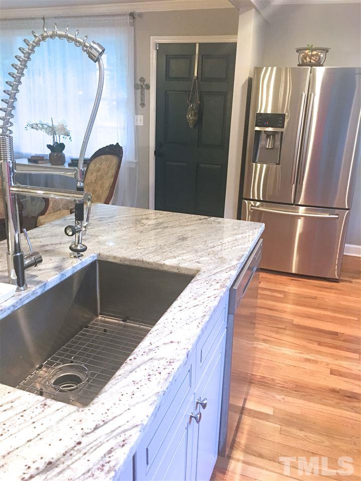 512 Rose Lane Raleigh, NC 27610 - Photo 4 of 22 a kitchen with stainless steel appliances granite countertop a sink stove and refrigerator