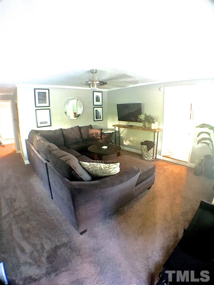 512 Rose Lane Raleigh, NC 27610 - Photo 8 of 22 a living room with furniture and a flat screen tv