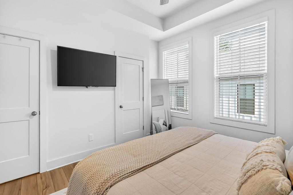 4455 Dandelion Lane Atlanta, GA 30342 - Photo 29 of 44 a bedroom with a large bed and a flat screen tv