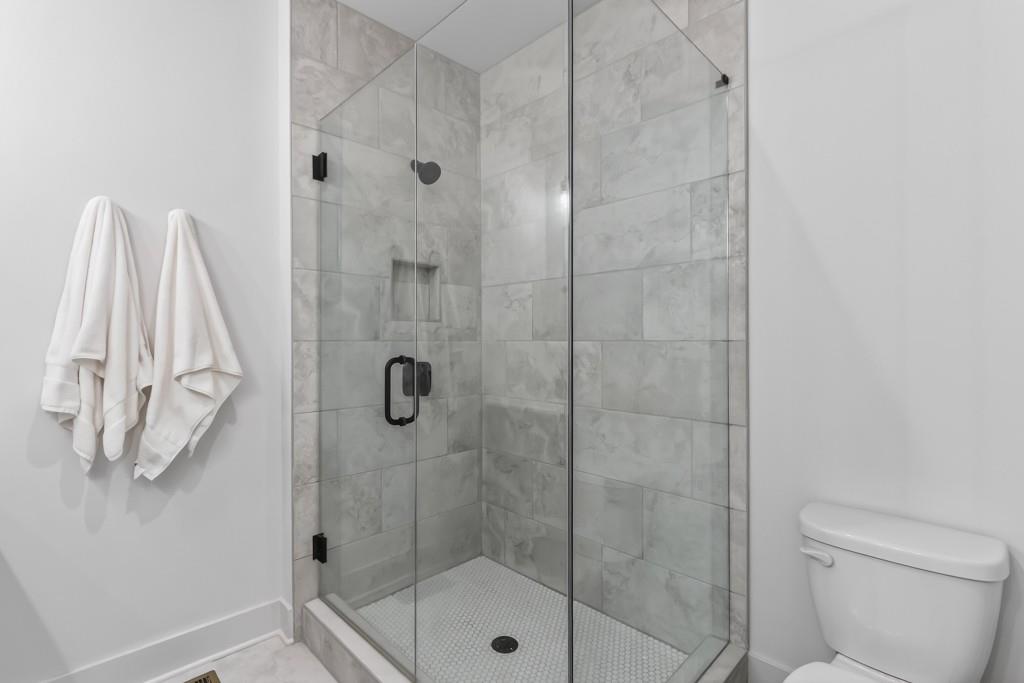 4455 Dandelion Lane Atlanta, GA 30342 - Photo 33 of 44 a bathroom with a shower and toilet