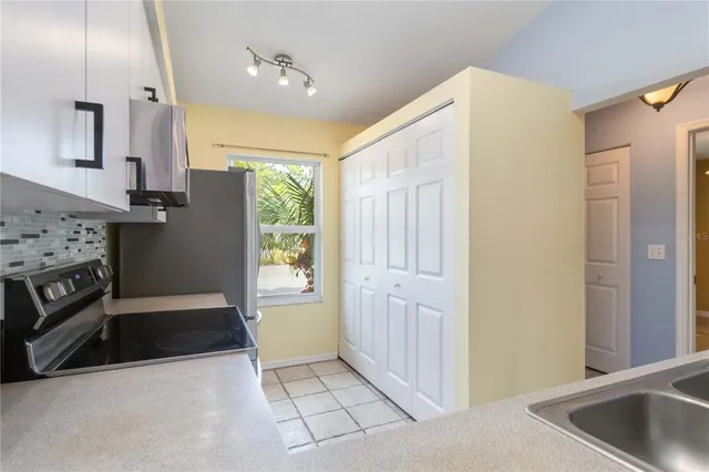 a kitchen with stainless steel appliances a refrigerator and a sink