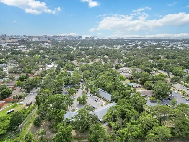 an aerial view of residential building with green space