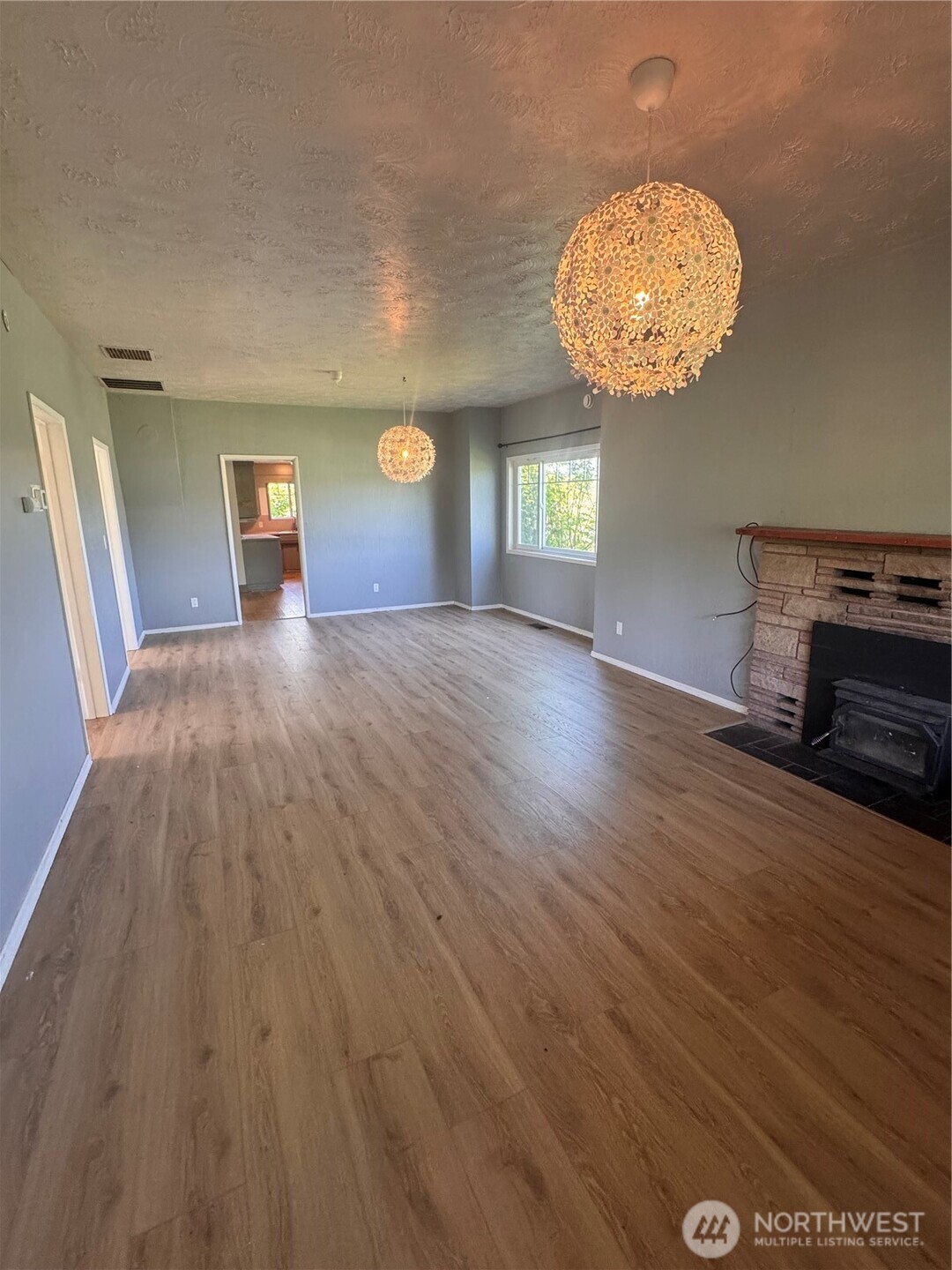 20016 Orville Road East Orting, WA 98360 - Photo 12 of 18 a view of a room with wooden floor and windows