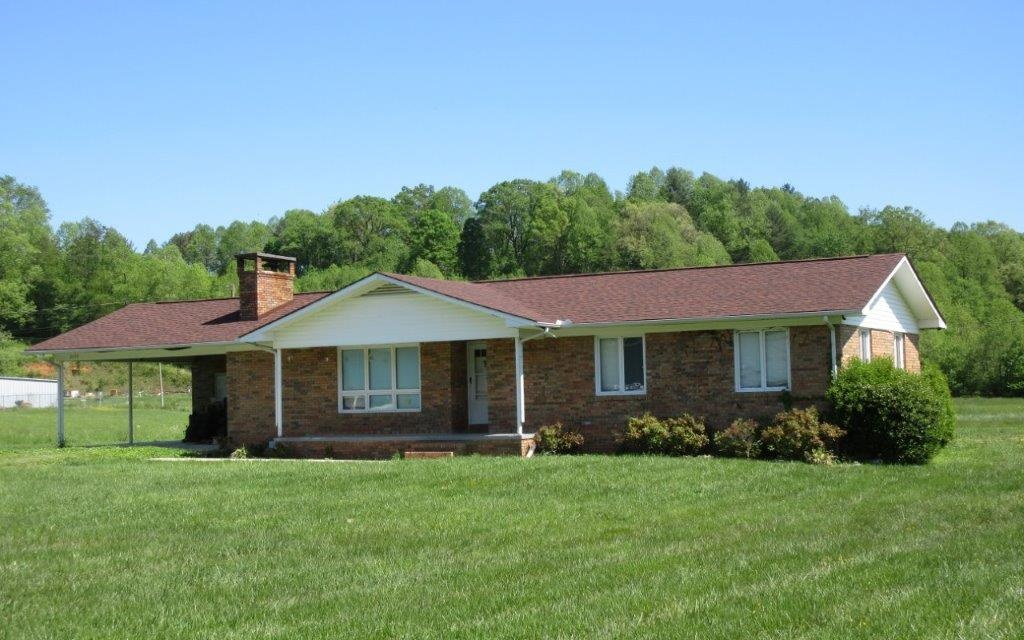 2420 Airport Road Marble, NC 28905 - Photo 1 of 1 a front view of a house with a garden