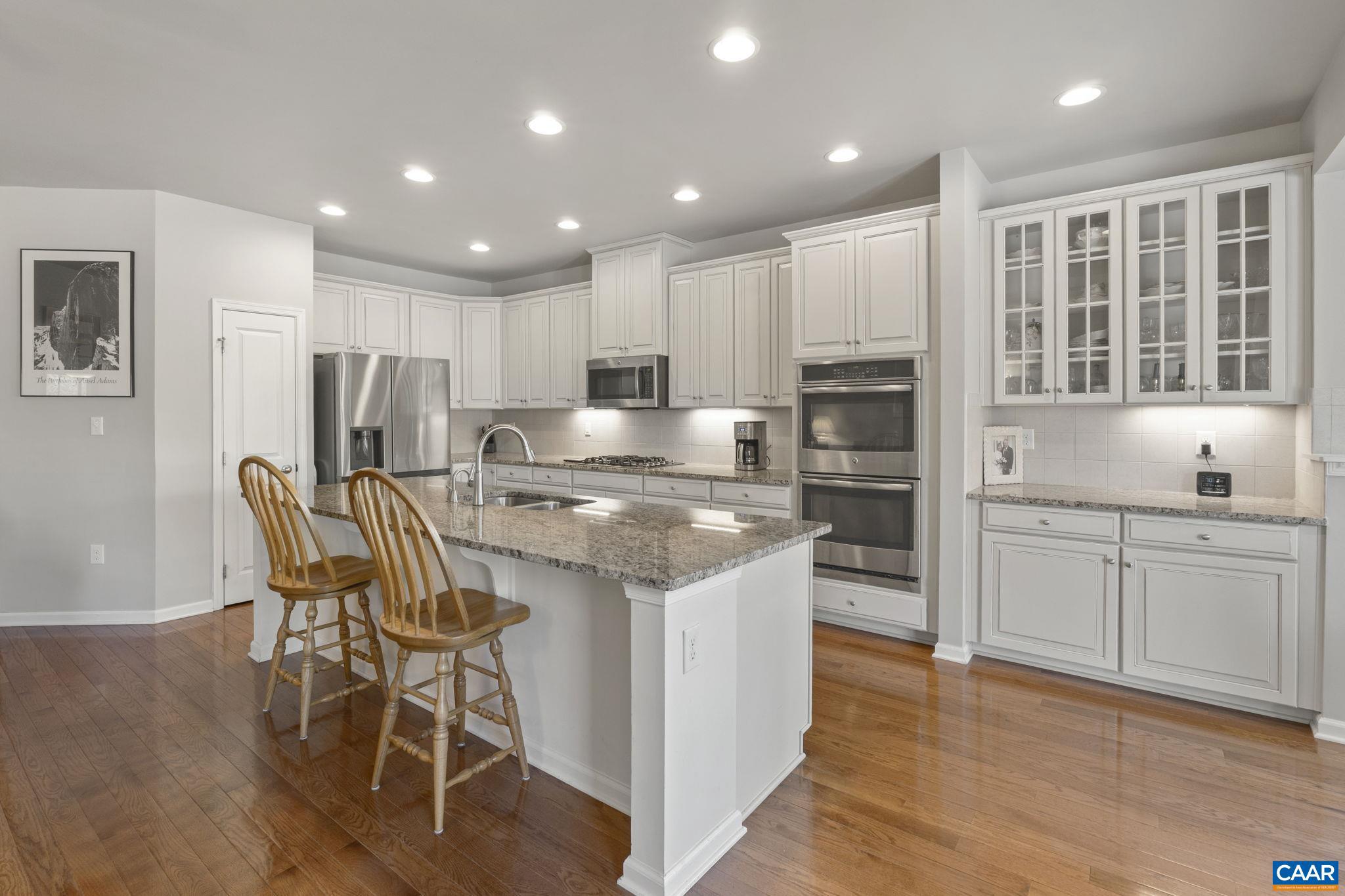 1377 Delphi Lane Charlottesville, VA 22911 - Photo 12 of 48 a kitchen with kitchen island granite countertop wooden floors and stainless steel appliances