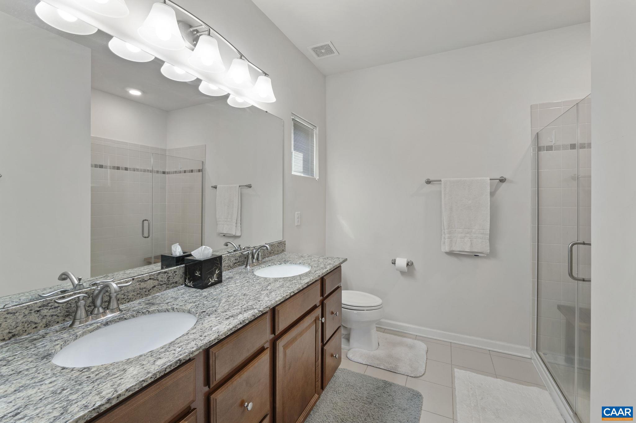 1377 Delphi Lane Charlottesville, VA 22911 - Photo 23 of 48 a bathroom with a granite countertop double vanity sink and mirror with shower