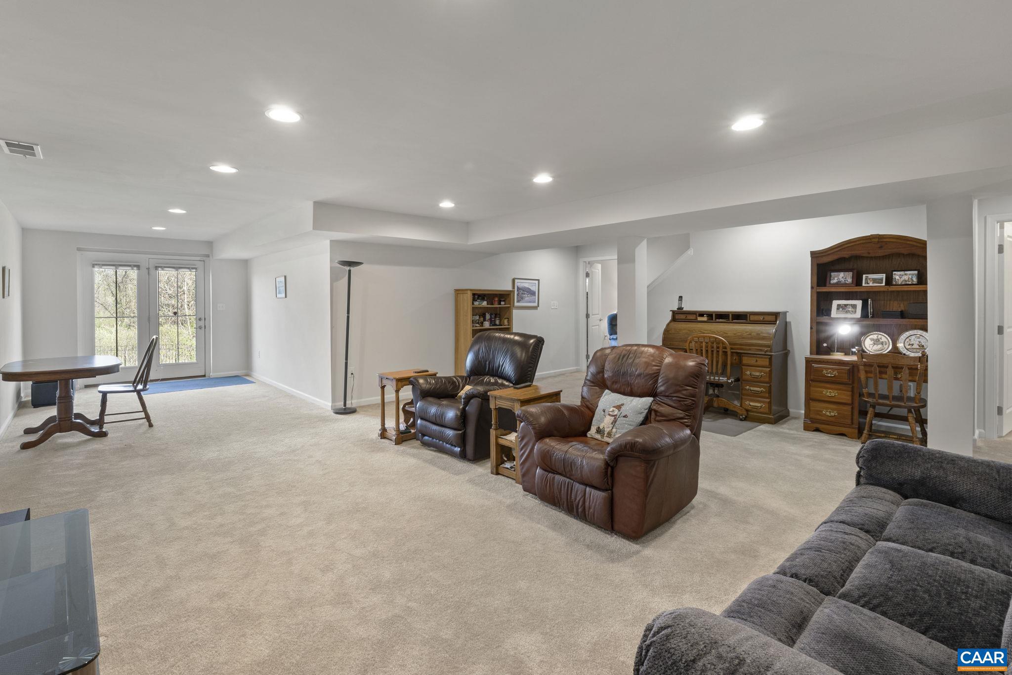 1377 Delphi Lane Charlottesville, VA 22911 - Photo 32 of 48 a living room with furniture and a flat screen tv