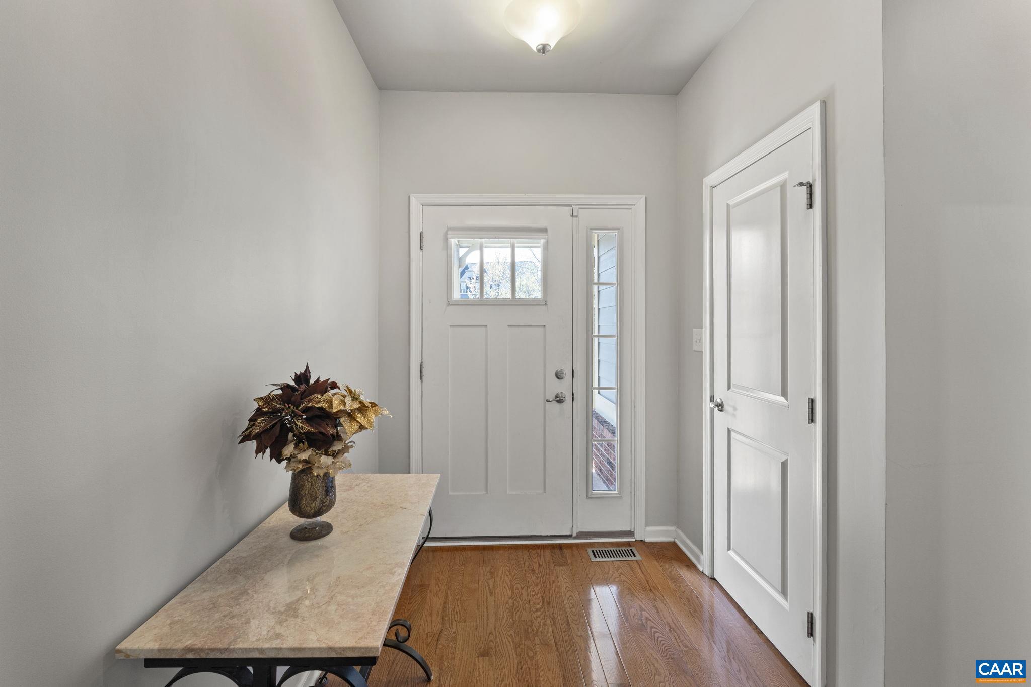1377 Delphi Lane Charlottesville, VA 22911 - Photo 6 of 48 a room with a table and a chandelier