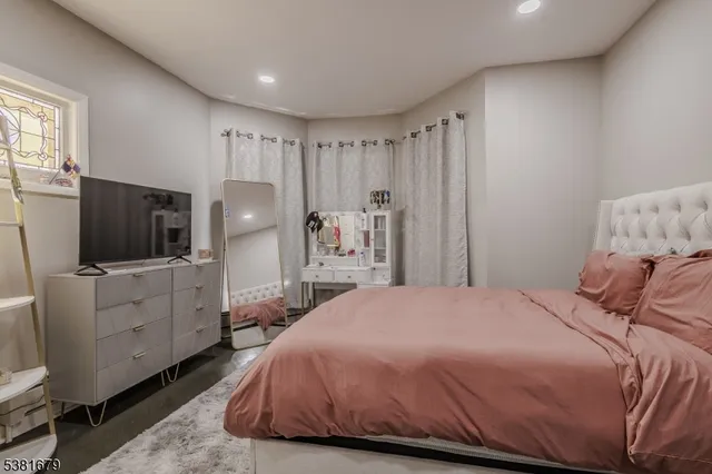 a bedroom with a bed and flat screen tv