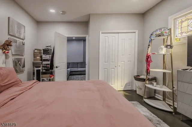 a large bedroom with bed and window