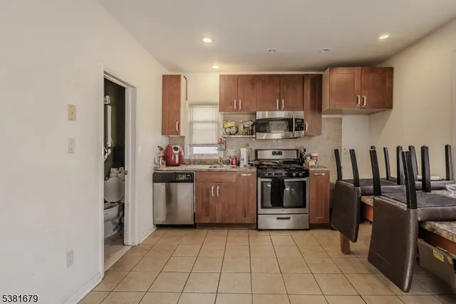 a kitchen with a sink a stove and refrigerator