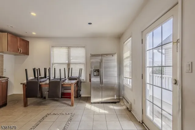 a view of kitchen with windows and refrigerator