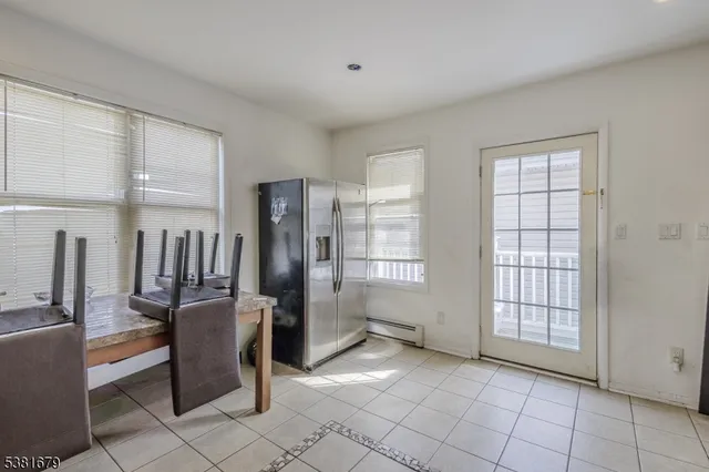 a view of a roof deck with table and chairs a barbeque with wooden floor and fence