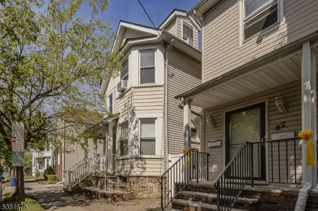 a front view of a house with parking space