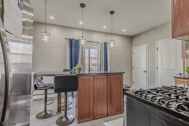 a kitchen with stainless steel appliances granite countertop a stove and a refrigerator