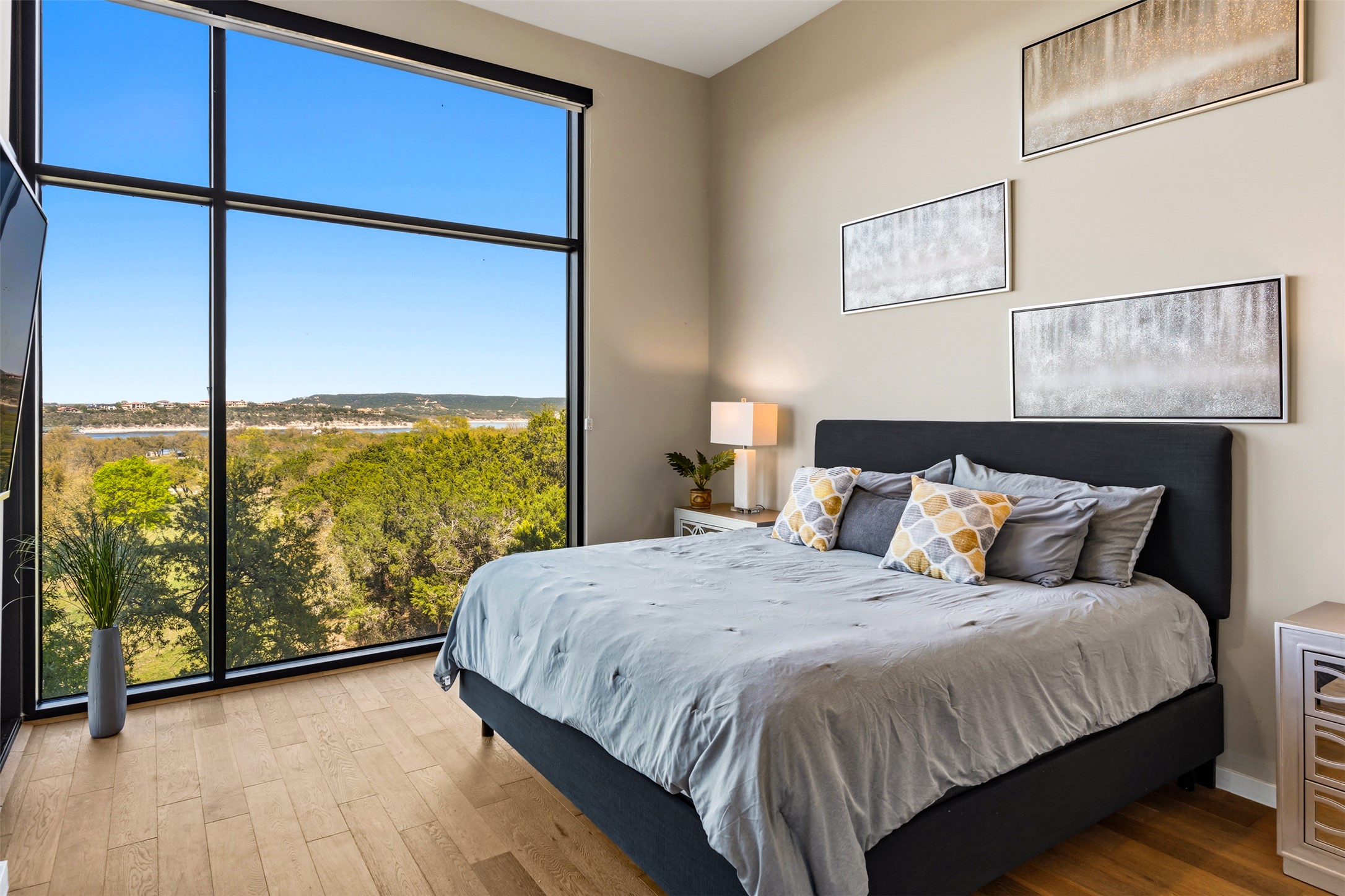 5921 Hiline Road, Unit 2304 Austin, TX 78734 - Photo 21 of 39 a bed sitting in a bedroom next to a large window