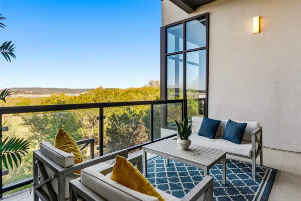 a view of a living room with furniture and floor to ceiling window