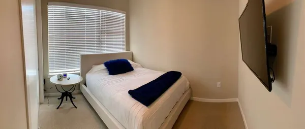 a bedroom with a bed and a chair