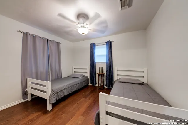 a bathroom with a sink a toilet and shower curtain