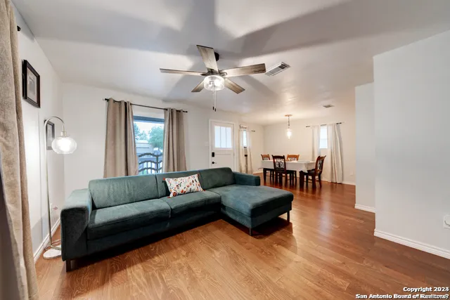 a dining room with furniture window and wooden floor