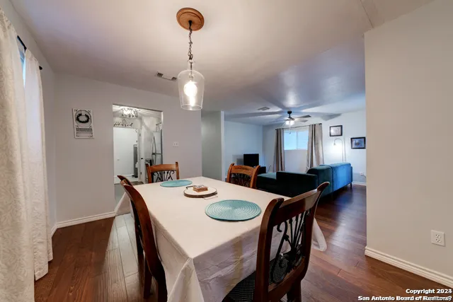 a kitchen with stainless steel appliances a stove cabinets and a wooden floor