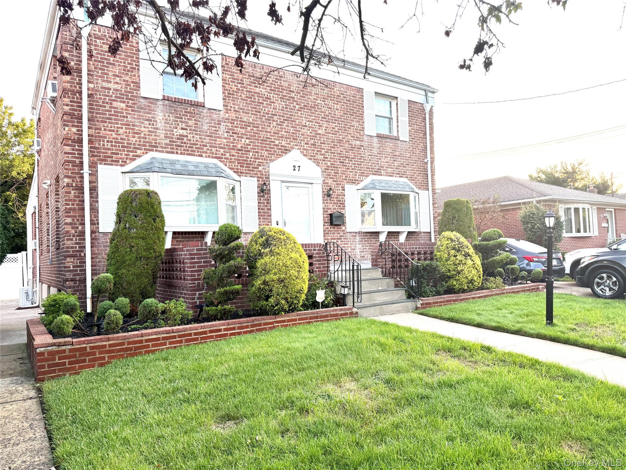 a front view of a house with garden