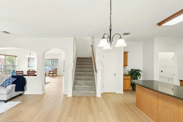 a bathroom with a granite countertop toilet sink and mirror
