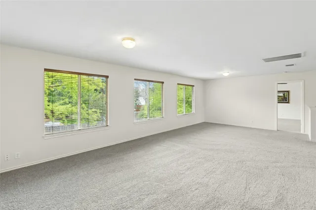 a view of an empty room with windows