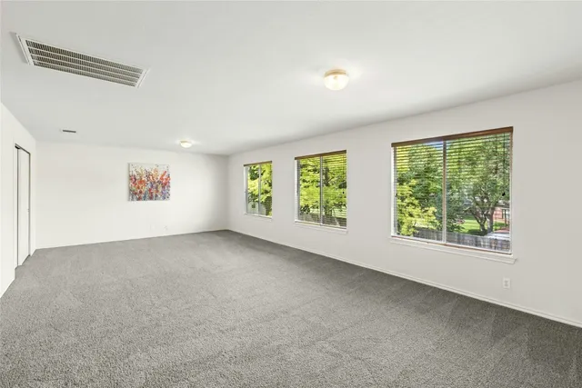 a view of a patio with a table chairs and a yard