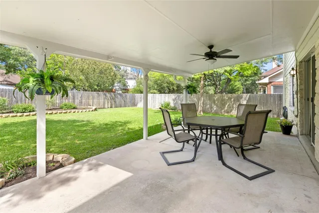 a view of a house with a backyard