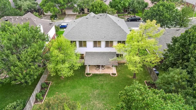 an aerial view of a house with a yard