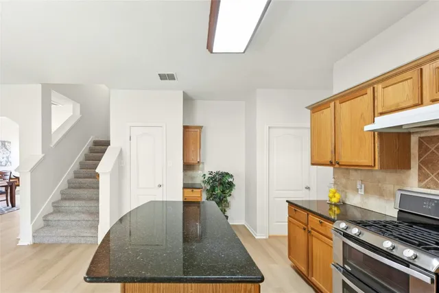 a view of kitchen with sink and wooden floor