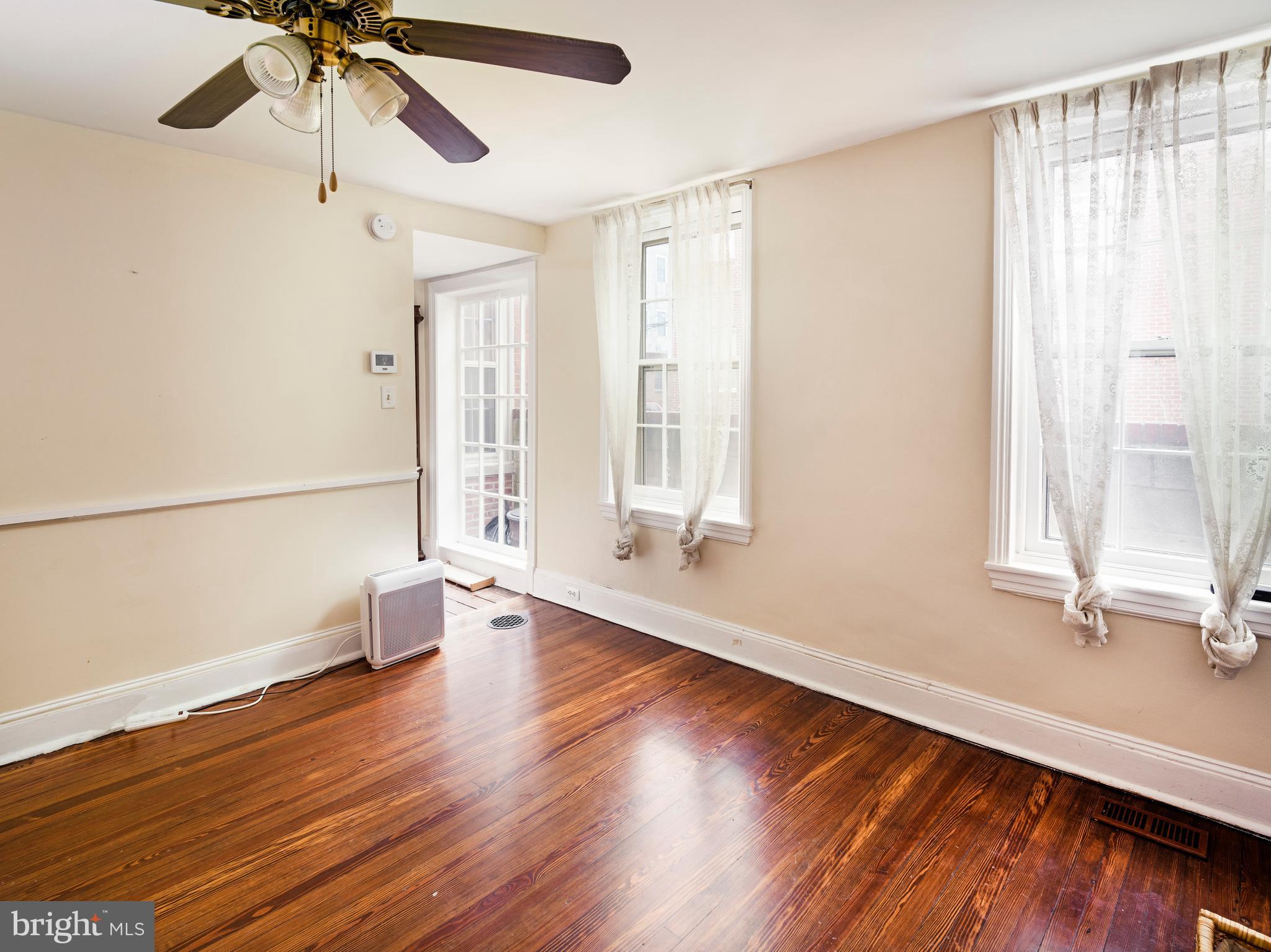 223 Carpenter Street Philadelphia, PA 19147 - Photo 17 of 42 a view of an empty room with a window and wooden floor