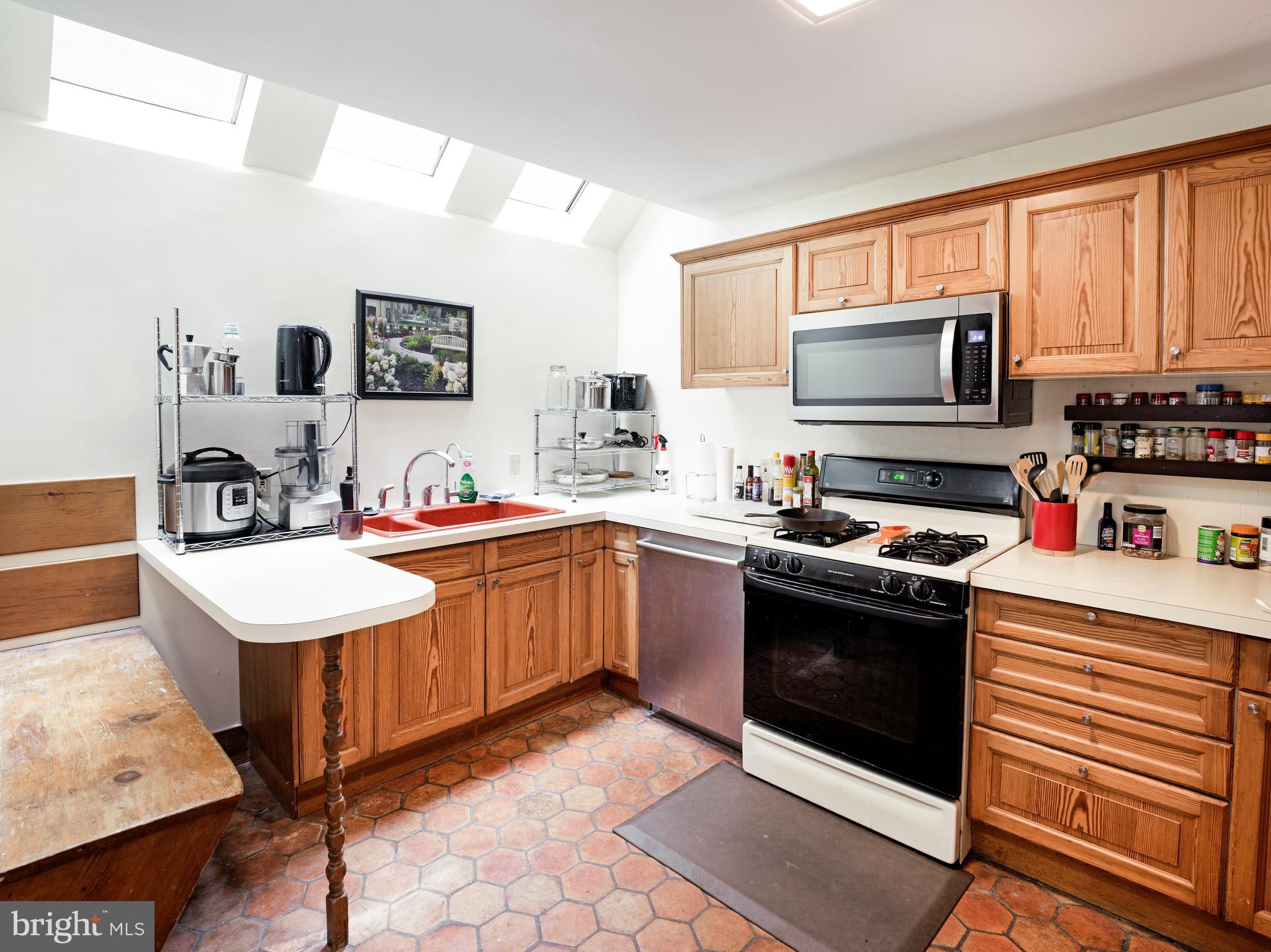 223 Carpenter Street Philadelphia, PA 19147 - Photo 18 of 42 a kitchen with a sink stove top oven and microwave