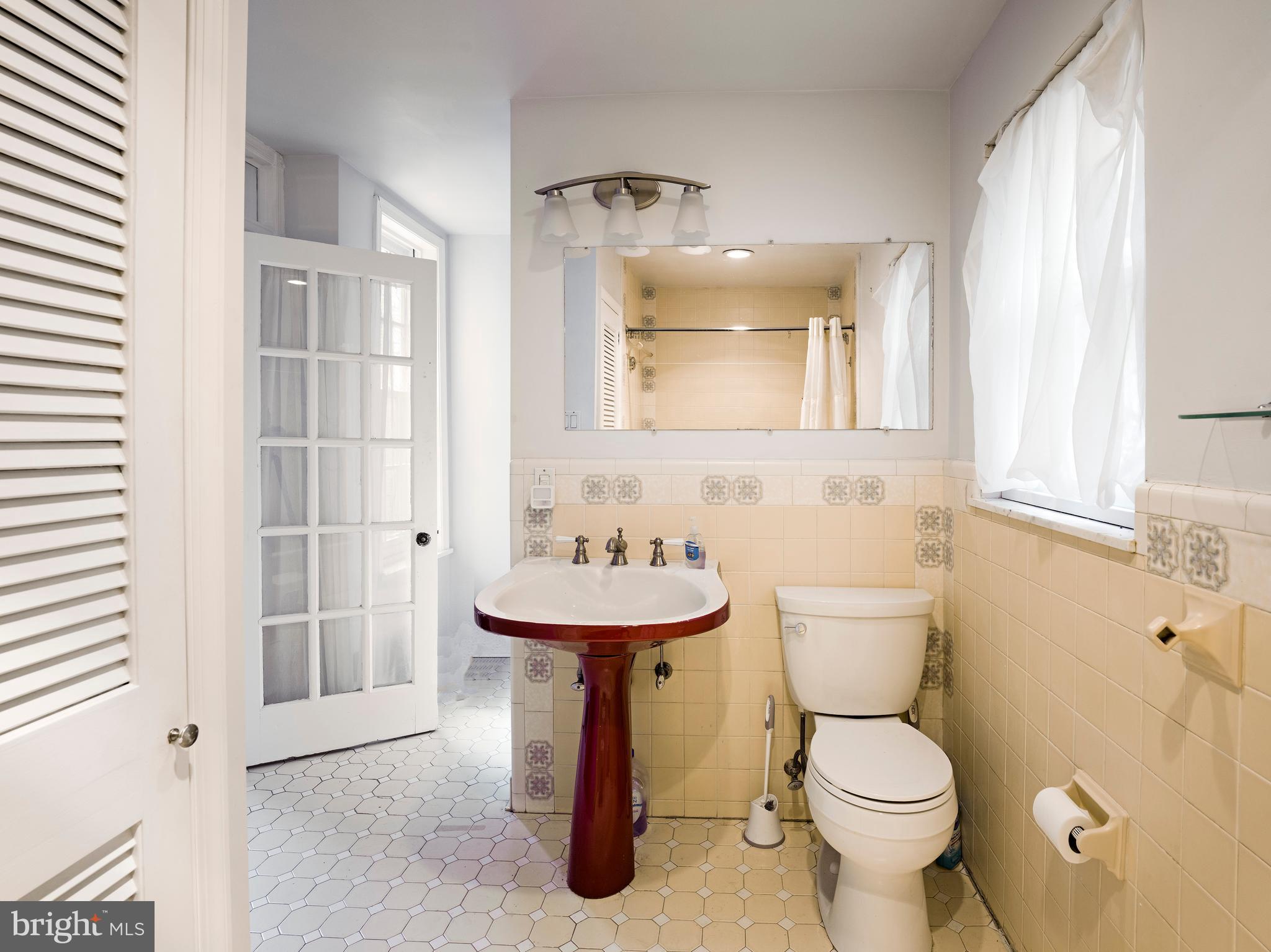 223 Carpenter Street Philadelphia, PA 19147 - Photo 23 of 42 a bathroom with a toilet sink and mirror