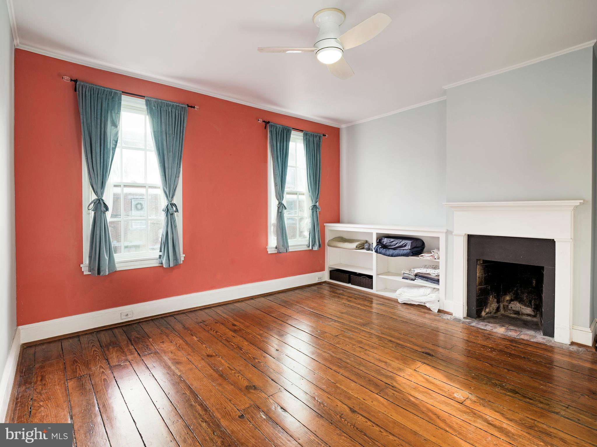 223 Carpenter Street Philadelphia, PA 19147 - Photo 28 of 42 a living room with furniture and a fireplace