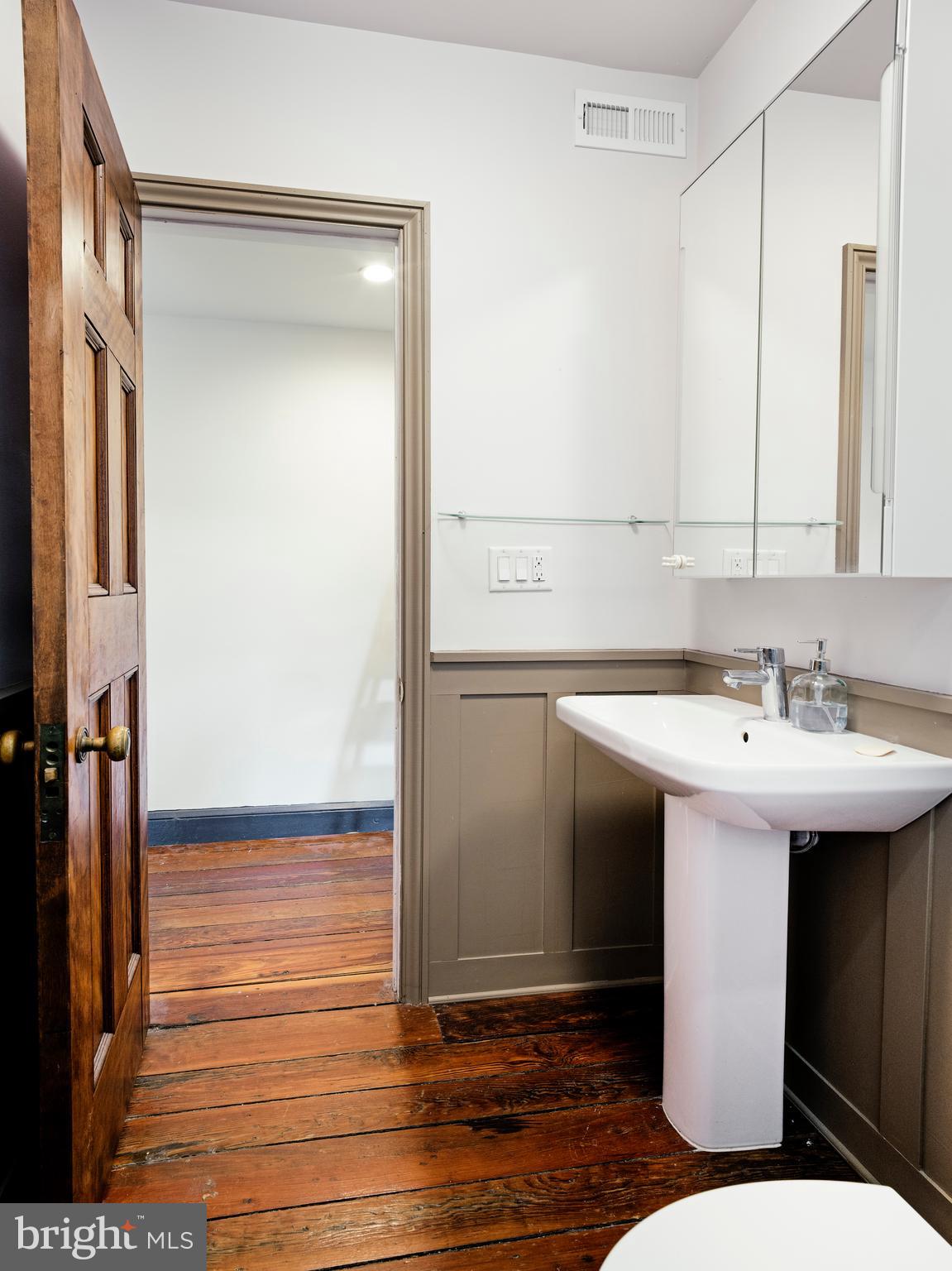 223 Carpenter Street Philadelphia, PA 19147 - Photo 42 of 42 a bathroom with a sink and mirror