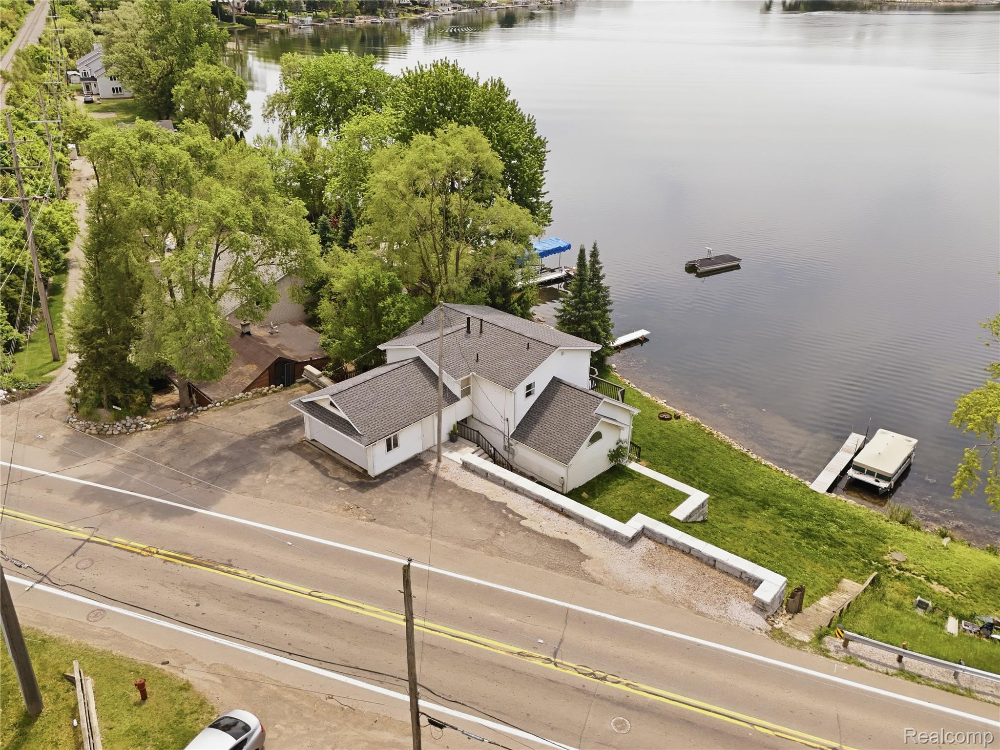 7217 Andersonville Road Clarkston, MI 48346 - Photo 55 of 65 Waterfront property featuring a white exterior with dark gray roofing