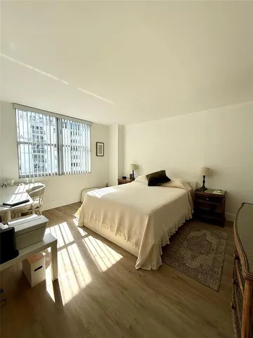 a bedroom with a bed and a night stand