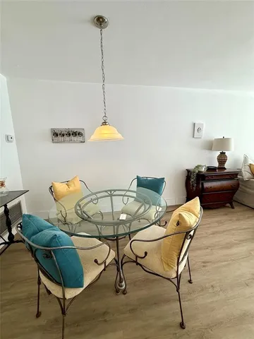 a kitchen with white cabinets and appliances